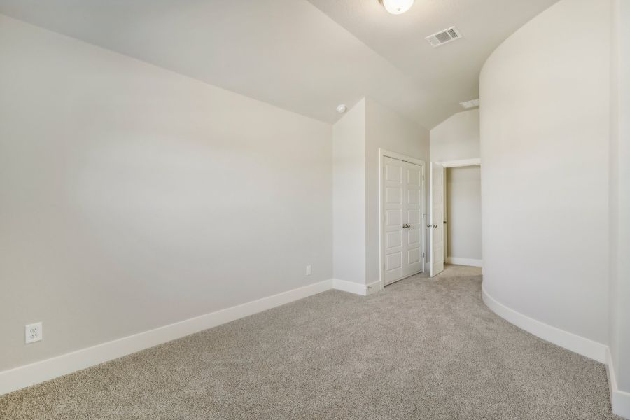 Guest bedroom in the Cedar floorplan at a Meritage Homes community.