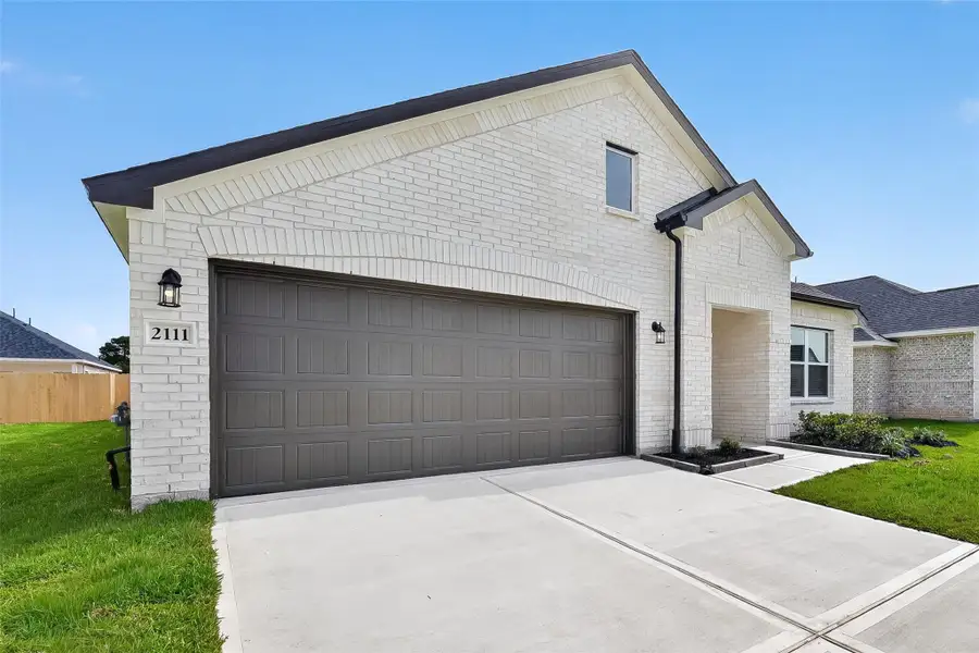 Front exterior of a new home in Rollingbrook Estates, Baytown, TX, highlighting curb appeal (Image 2). Front exterior of a new home in Rollingbrook Estates, Baytown, TX, highlighting curb appeal (Image 2).
