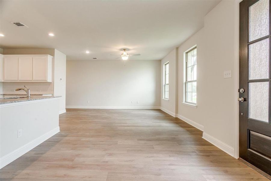 Foyer entrance featuring ceiling fan, sink, and light wood-type flooring