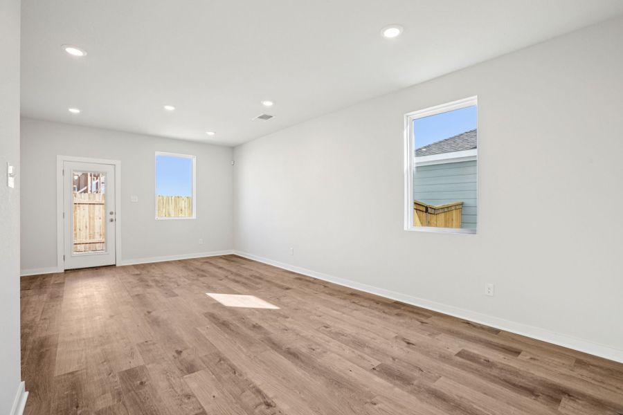 A room with a wood floor and a wood floor with a window. A room with a wood floor and a wood floor with a window.