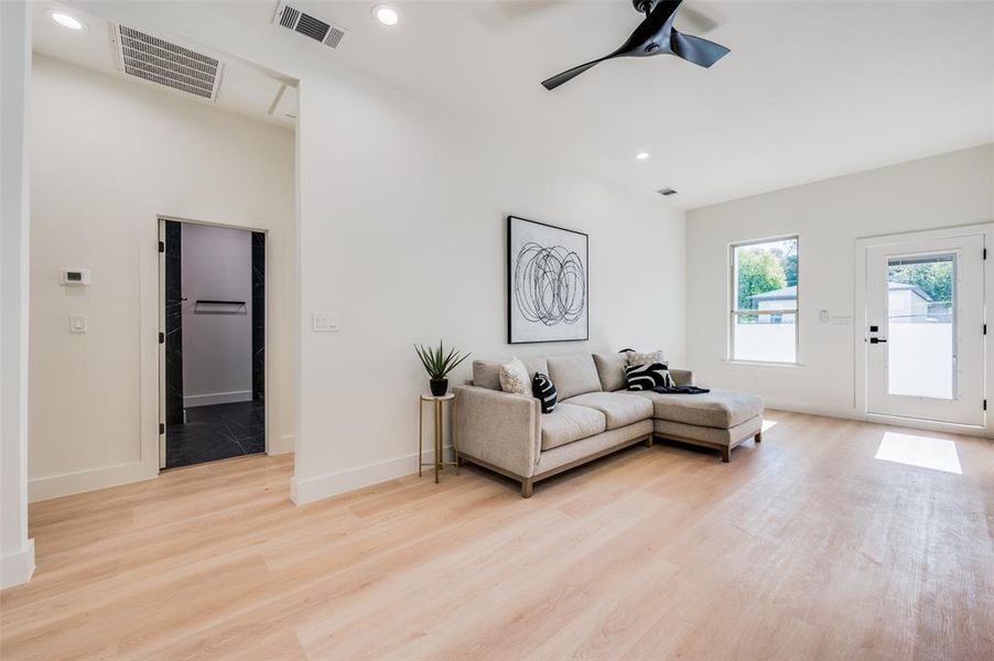 Living room featuring light hardwood / wood-style flooring and ceiling fan