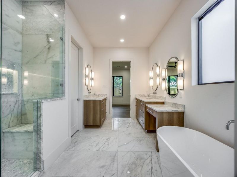 Bathroom featuring a healthy amount of sunlight, independent shower and bath, and vanity