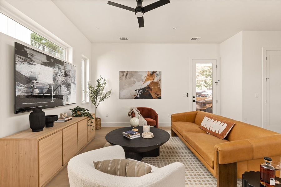 Living room with a ceiling fan and recessed lighting