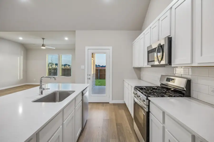 Kitchen in the Wimbledon home plan by Trophy Signature Homes – REPRESENTATIVE PHOTO Kitchen in the Wimbledon home plan by Trophy Signature Homes – REPRESENTATIVE PHOTO