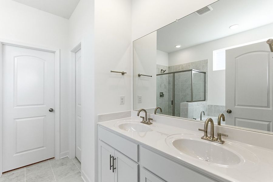 A bathroom with a large mirror.