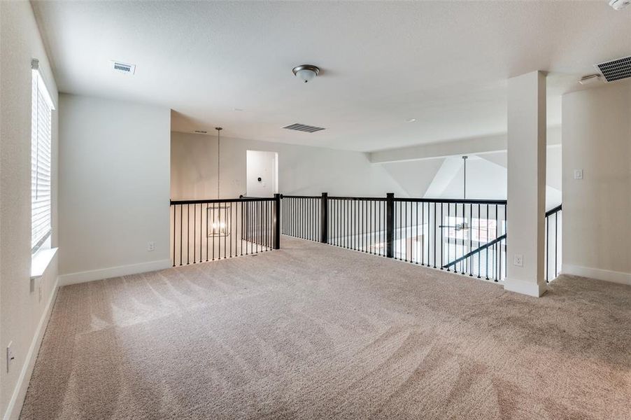 Carpeted empty room with healthy amount of natural light and baseboards Carpeted empty room with healthy amount of natural light and baseboards