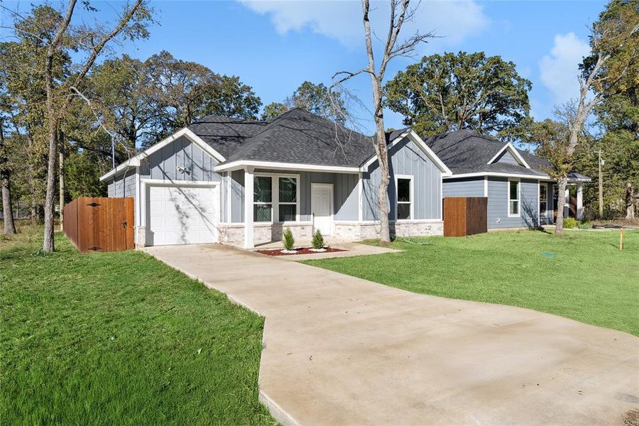 View of front of home with a garage and a front yard