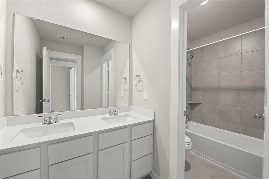 Secondary Bathroom with dual sinks outside of tub/shower combo. Very convenient to guests and other residents to utilize the bathroom.
