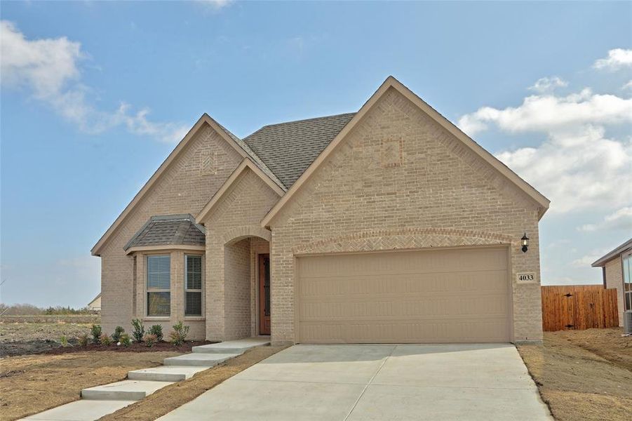 View of front of property featuring a garage