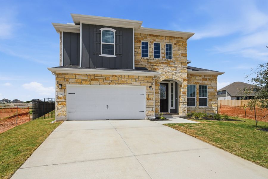 Front exterior of a new home in Santa Rita Ranch, Liberty Hill, TX, highlighting curb appeal (Image 26). Front exterior of a new home in Santa Rita Ranch, Liberty Hill, TX, highlighting curb appeal (Image 26).