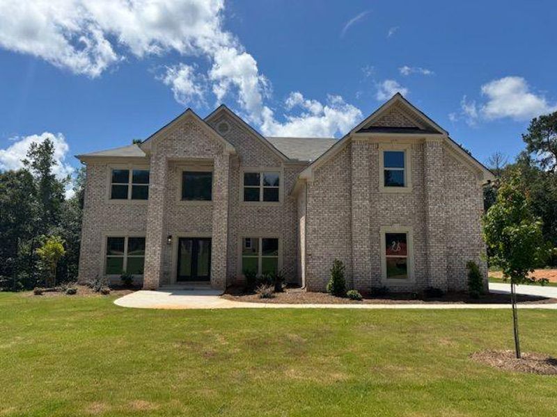 Front exterior of a new home in Underwood Crossing, Covington, GA, highlighting curb appeal (Image 1).