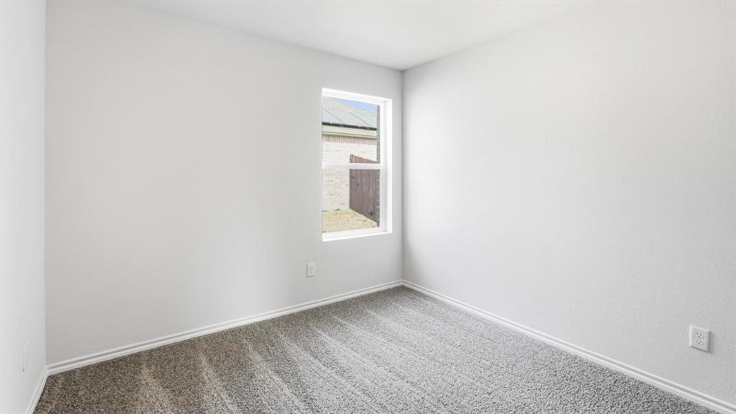 Spare room featuring carpet flooring and baseboards Spare room featuring carpet flooring and baseboards