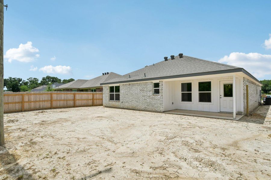 A newly constructed residence features a brick exterior and a fenced backyard, ready for personalization. A newly constructed residence features a brick exterior and a fenced backyard, ready for personalization.