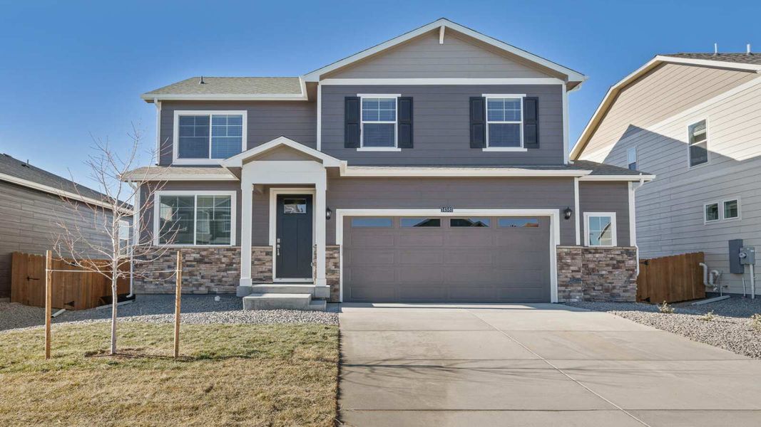 Front exterior of a new home in Vista Meadows, Fort Lupton, CO, highlighting curb appeal (Image 1). Front exterior of a new home in Vista Meadows, Fort Lupton, CO, highlighting curb appeal (Image 1).