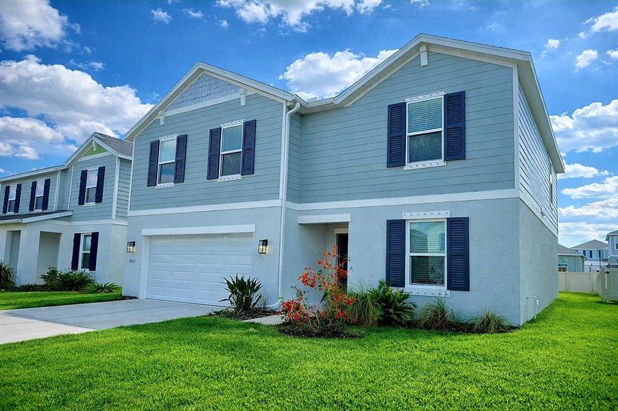 Front exterior of a new home in Broadleaf, Parrish, FL, highlighting curb appeal (Image 33).