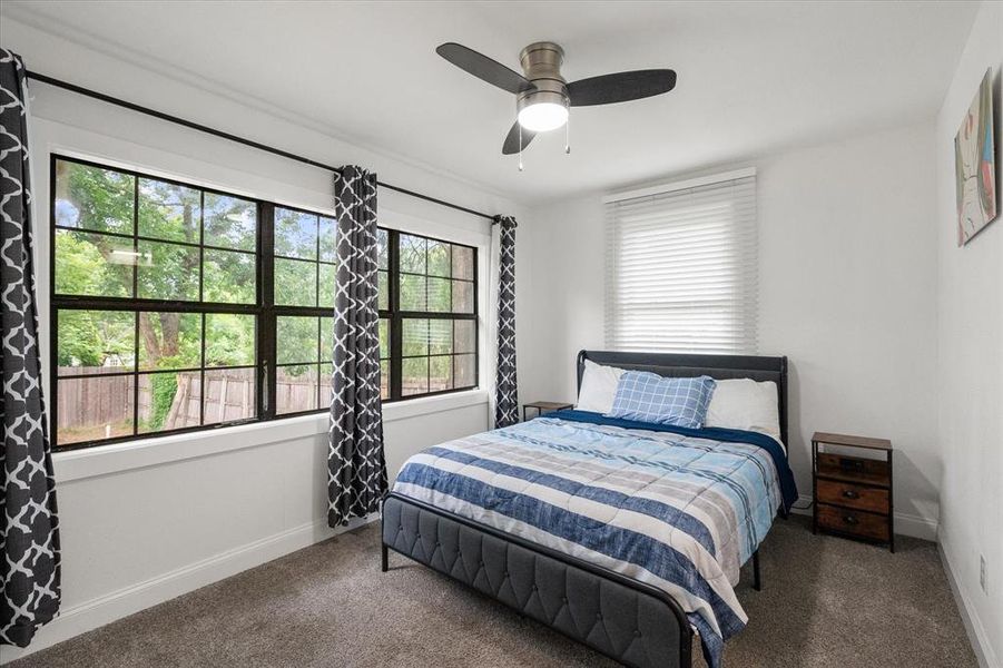 Bedroom with carpet, multiple windows, and ceiling fan Bedroom with carpet, multiple windows, and ceiling fan