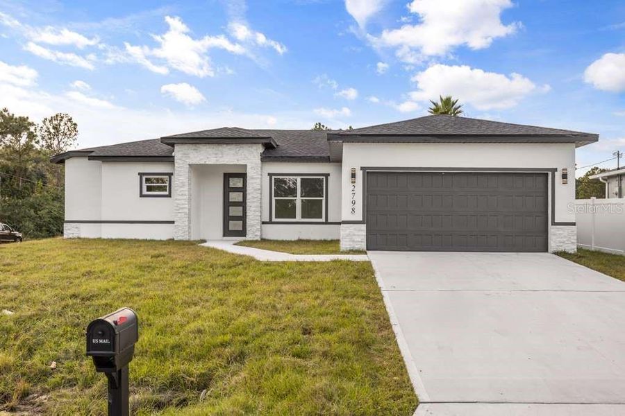 Front exterior of a new home in , Palm Bay, FL, highlighting curb appeal (Image 1). Front exterior of a new home in , Palm Bay, FL, highlighting curb appeal (Image 1).