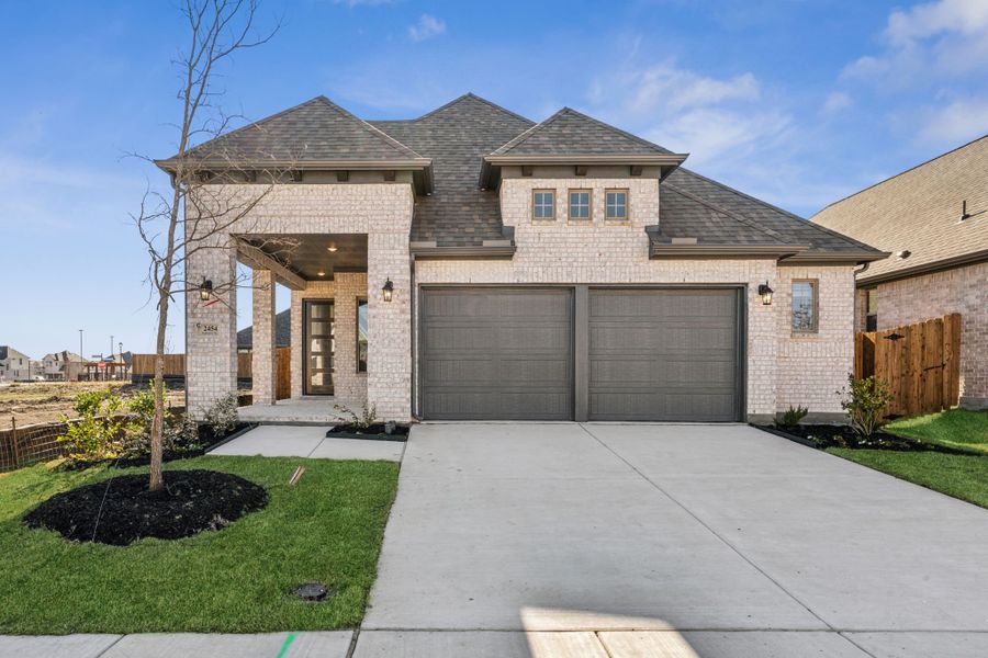 Front exterior of a new home in Avondale, Fate, TX, highlighting curb appeal (Image 18). Front exterior of a new home in Avondale, Fate, TX, highlighting curb appeal (Image 18).