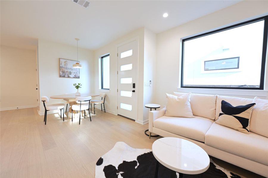 This open-concept living space with large windows providing natural light