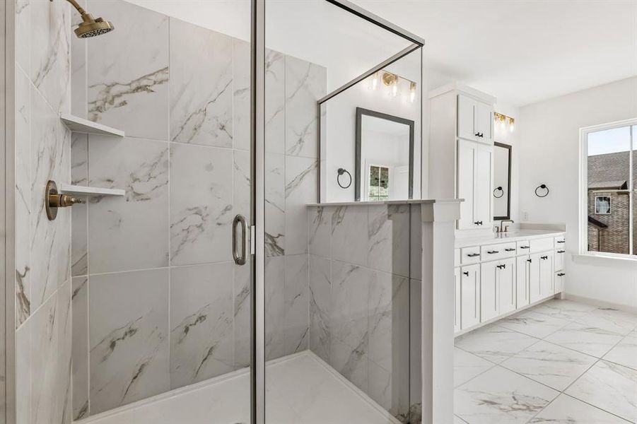 A spacious, walk in shower is the cherry on top in this beautiful Owner's bath.