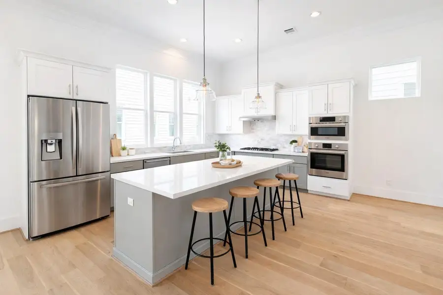 Spacious kitchen with oversized island and loads of natural light! Virtual staging added.