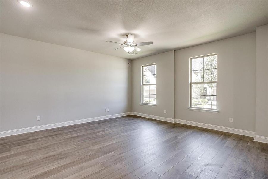 Unfurnished bedroom with light carpet and baseboards