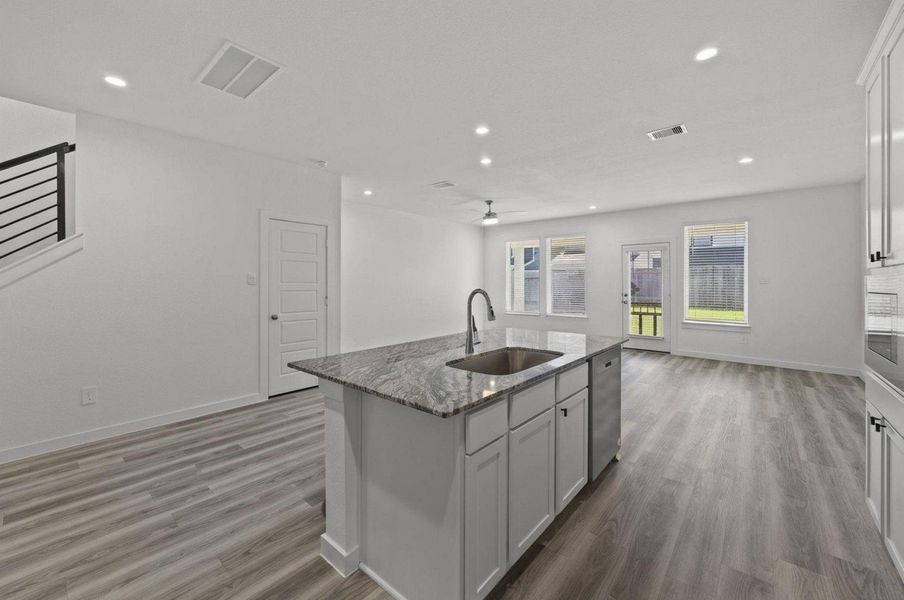 Spacious kitchen island opening to the dining room and living area Spacious kitchen island opening to the dining room and living area