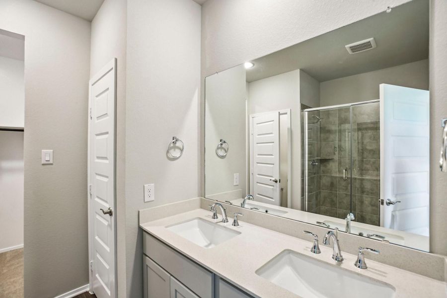 Designed for convenience, the primary bath features modern finishes and a practical layout.