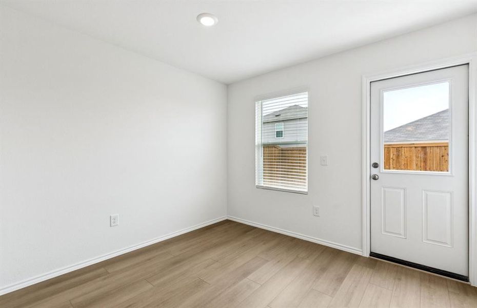 Dining nook off kitchen with large windows