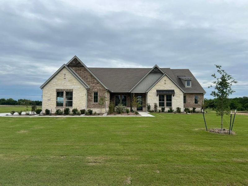 Front exterior of a new home in Fannin Ranch, Leonard, TX, highlighting curb appeal (Image 2). Front exterior of a new home in Fannin Ranch, Leonard, TX, highlighting curb appeal (Image 2).
