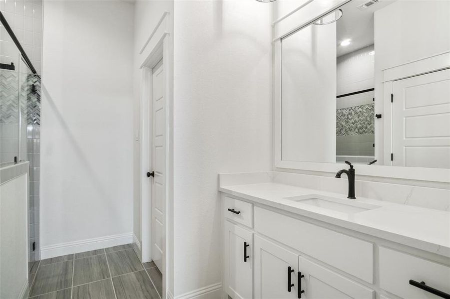 Full bathroom with a shower stall and vanity