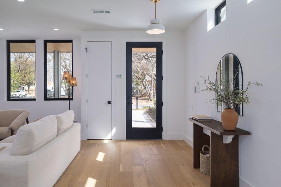 Foyer featuring light wood finished floors and recessed lighting