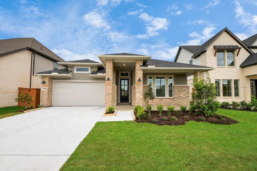 Front exterior of a new home in 50' Traditional Homes at Elyson, Katy, TX, highlighting curb appeal (Image 19). Front exterior of a new home in 50' Traditional Homes at Elyson, Katy, TX, highlighting curb appeal (Image 19).