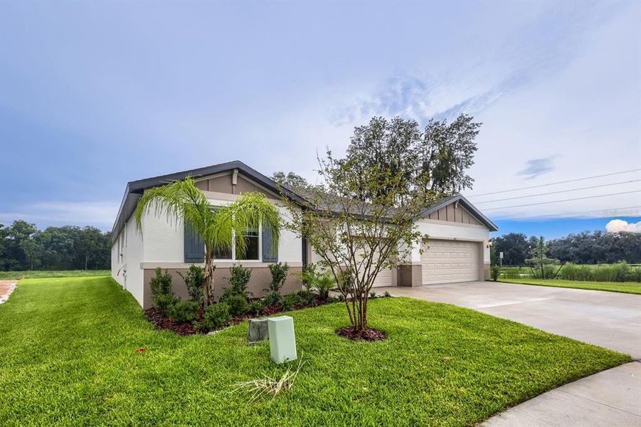 Front exterior of a new home in The Grove at Stuart Crossing - Signature Series, Bartow, FL, highlighting curb appeal (Image 1). Front exterior of a new home in The Grove at Stuart Crossing - Signature Series, Bartow, FL, highlighting curb appeal (Image 1).
