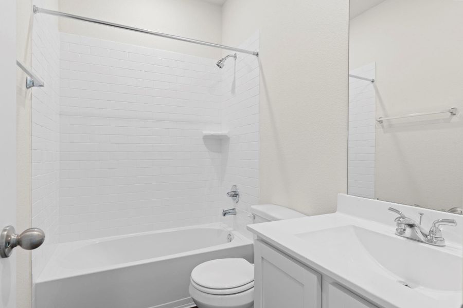Secondary full bath features a clean and modern design with a white vanity, sleek fixtures, and a convenient tub and shower combo—perfect for family or guests! Secondary full bath features a clean and modern design with a white vanity, sleek fixtures, and a convenient tub and shower combo—perfect for family or guests!