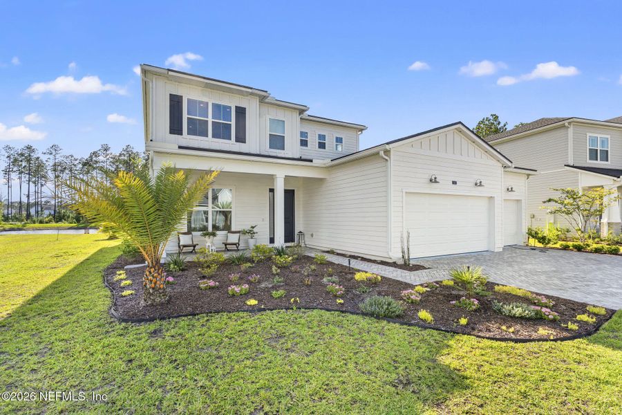 Front exterior of a new home in , St. Johns, FL, highlighting curb appeal (Image 1). Front exterior of a new home in , St. Johns, FL, highlighting curb appeal (Image 1).