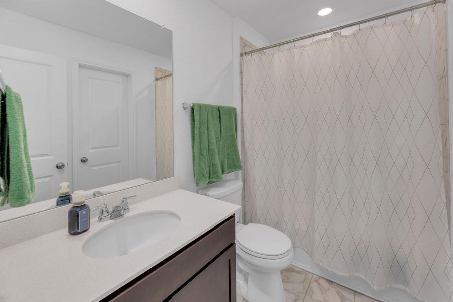 Full bathroom featuring toilet, recessed lighting, marble finish floor, and vanity