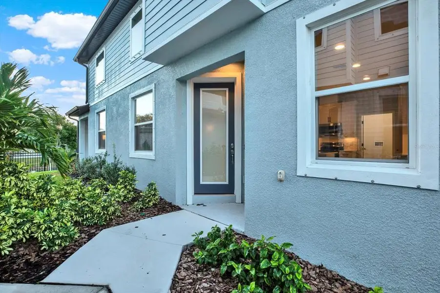Exterior details and patio area of a home in The Towns At Long Bayou, Seminole (Image 4).