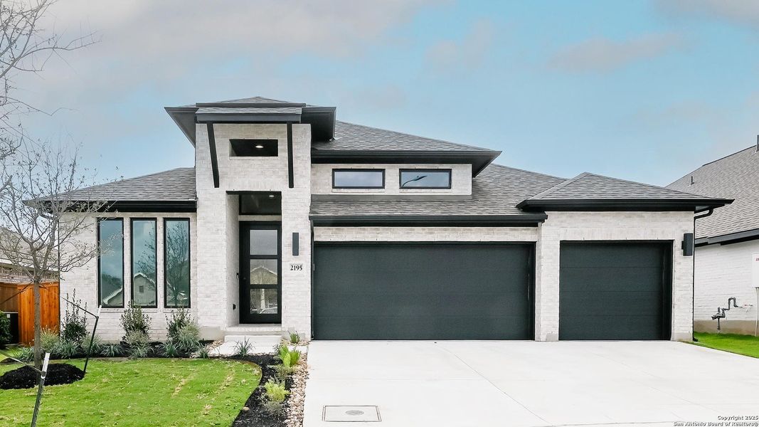 Front exterior of a new home in Veramendi 60', New Braunfels, TX, highlighting curb appeal (Image 15). Front exterior of a new home in Veramendi 60', New Braunfels, TX, highlighting curb appeal (Image 15).