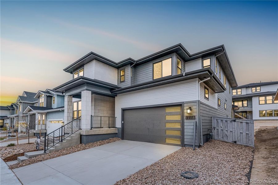 Front exterior of a new home in Legends at Lyric, Lone Tree, CO, highlighting curb appeal (Image 1). Front exterior of a new home in Legends at Lyric, Lone Tree, CO, highlighting curb appeal (Image 1).