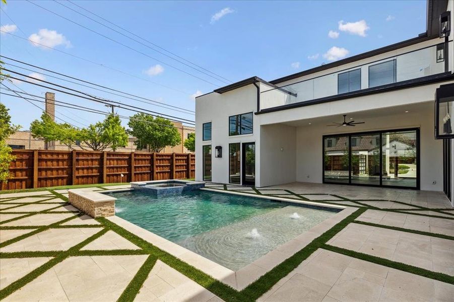 View of swimming pool featuring an in ground hot tub, ceiling fan, pool water feature, and a patio area