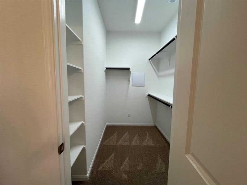 Built in shelving in master closet. For demonstration purposes only. This will be the same interior layout. Colors can vary.