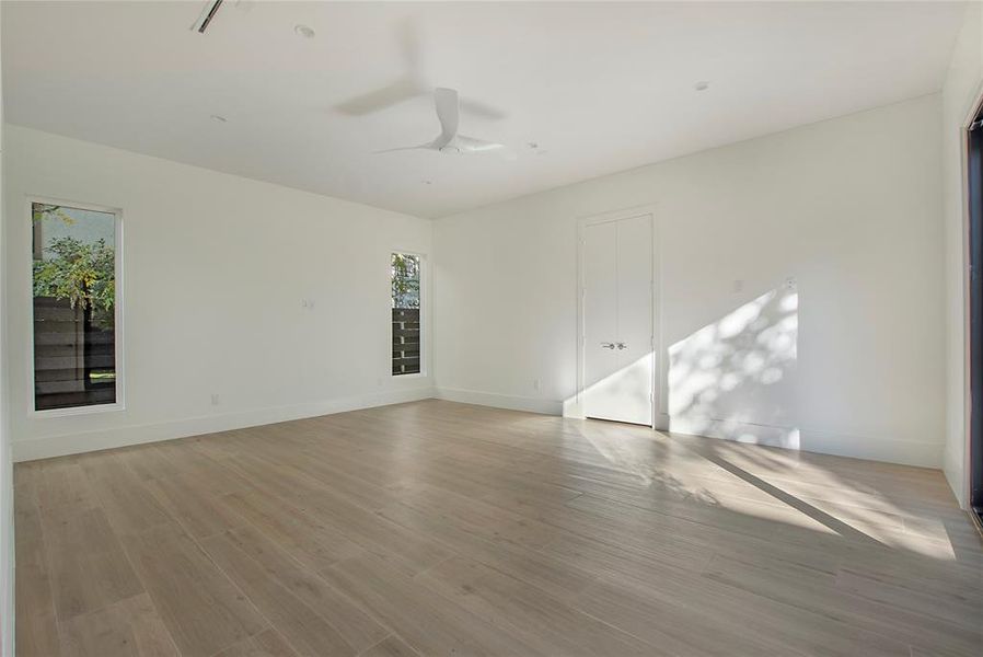 Empty room featuring ceiling fan and light hardwood / wood-style flooring