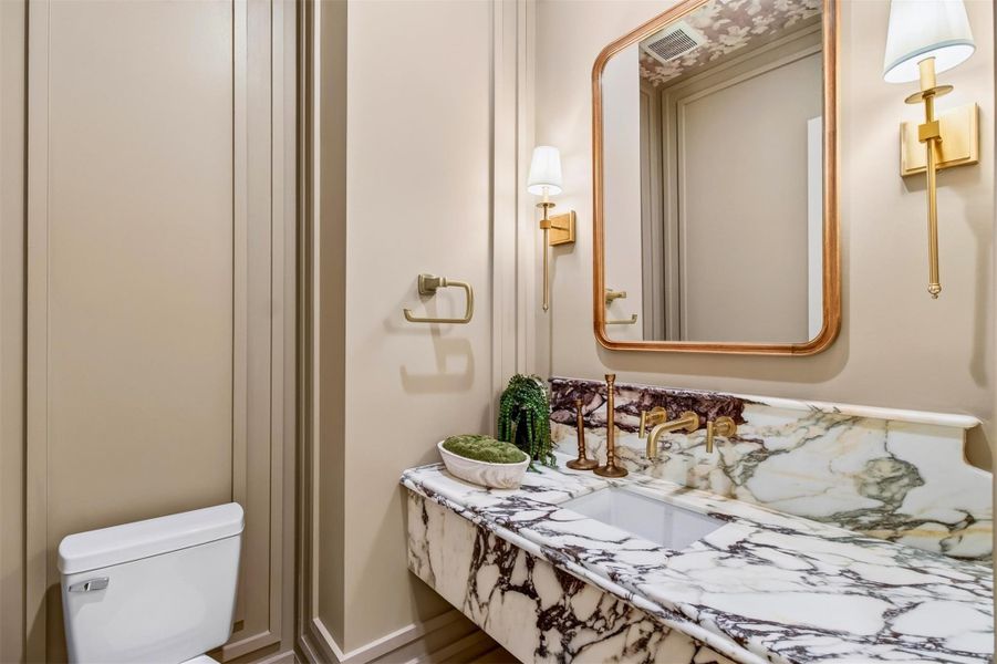 The stylish powder bath makes a lasting impression with elevated designer details and sophisticated finishes perfect for guests. The stylish powder bath makes a lasting impression with elevated designer details and sophisticated finishes perfect for guests.