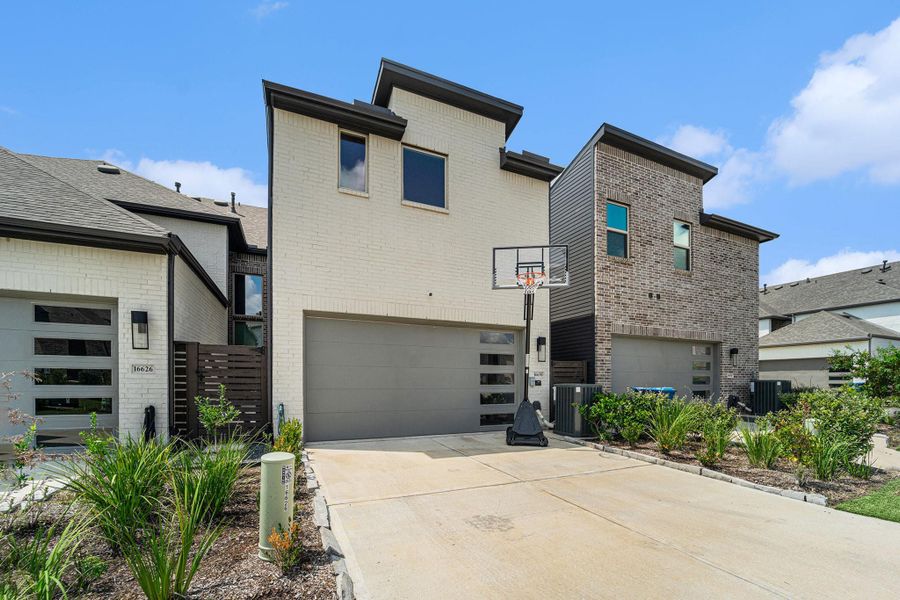 Two-car garage with clean modern lines and fenced side-yard access.