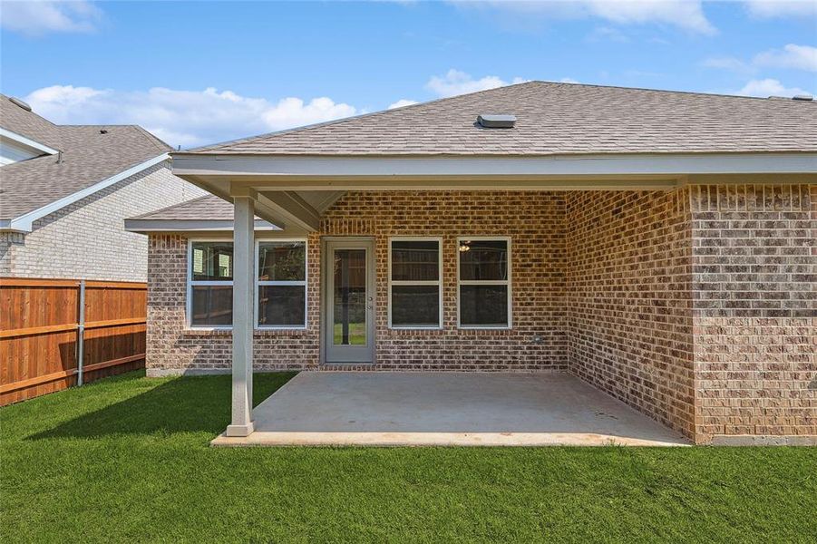 Back of property featuring a patio area and a yard