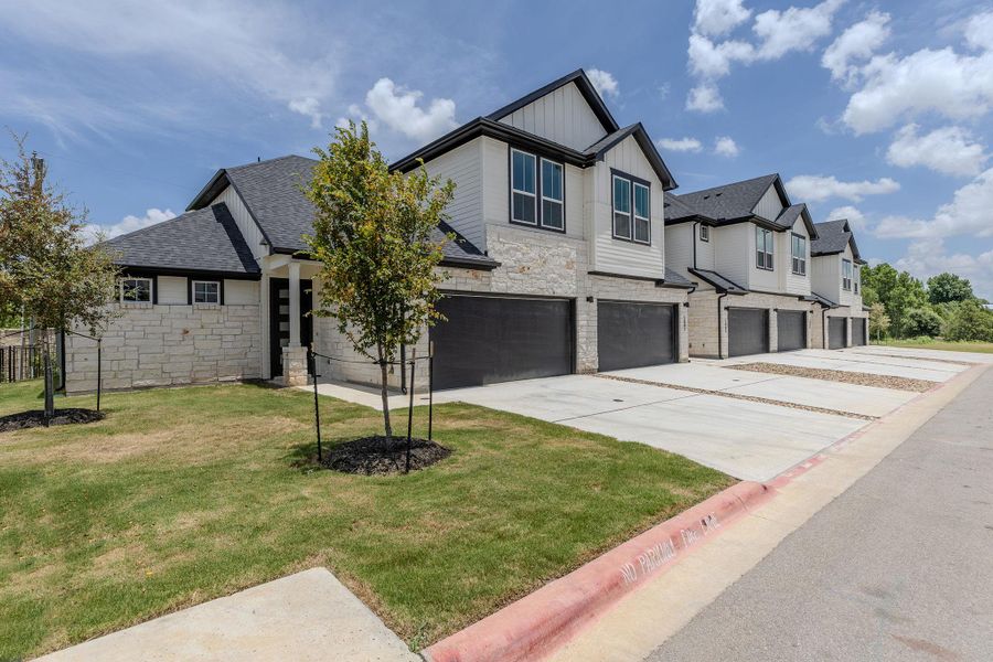 Clean lines and stacked stone accents define these contemporary townhomes with integrated garages.