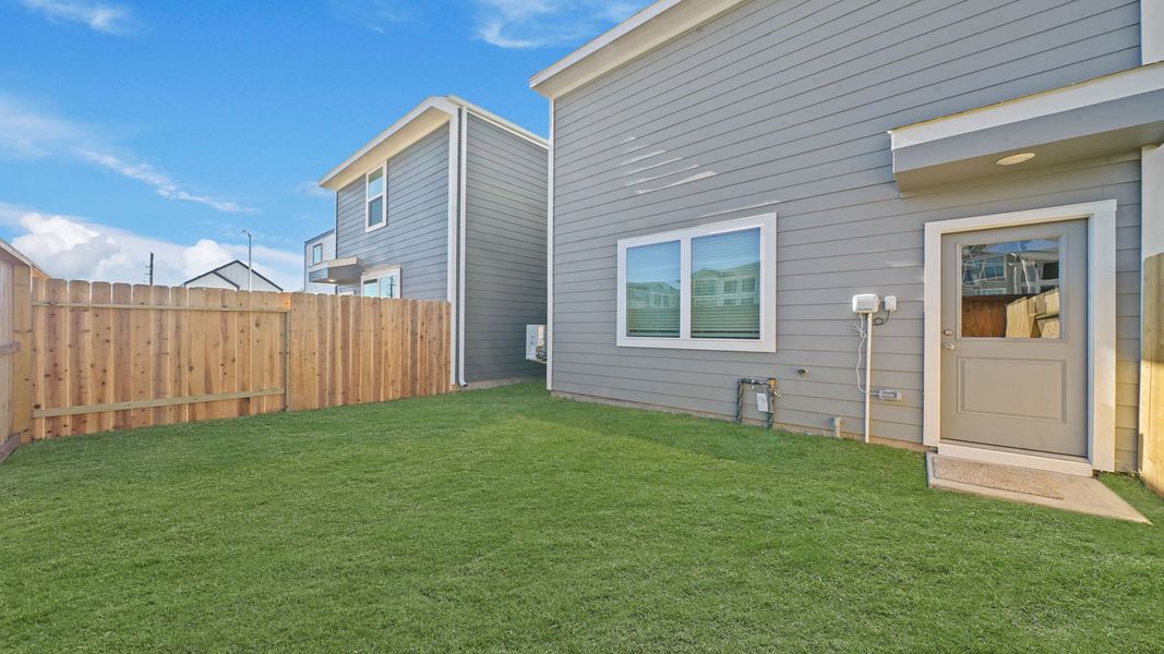 Exterior details and patio area of a home in Bridges on Lake Houston Villas, Humble (Image 3).
