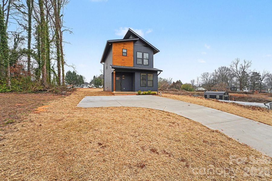 Front exterior of a new home in , Concord, NC, highlighting curb appeal (Image 14).