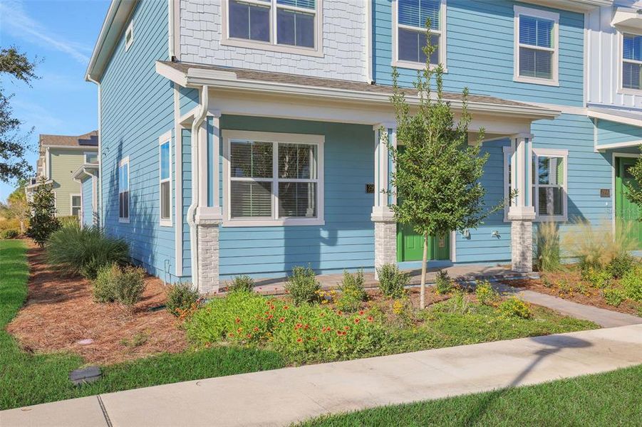 Exterior details and patio area of a home in Weslyn Park at Sunbridge (Craft Homes), St. Cloud (Image 18).